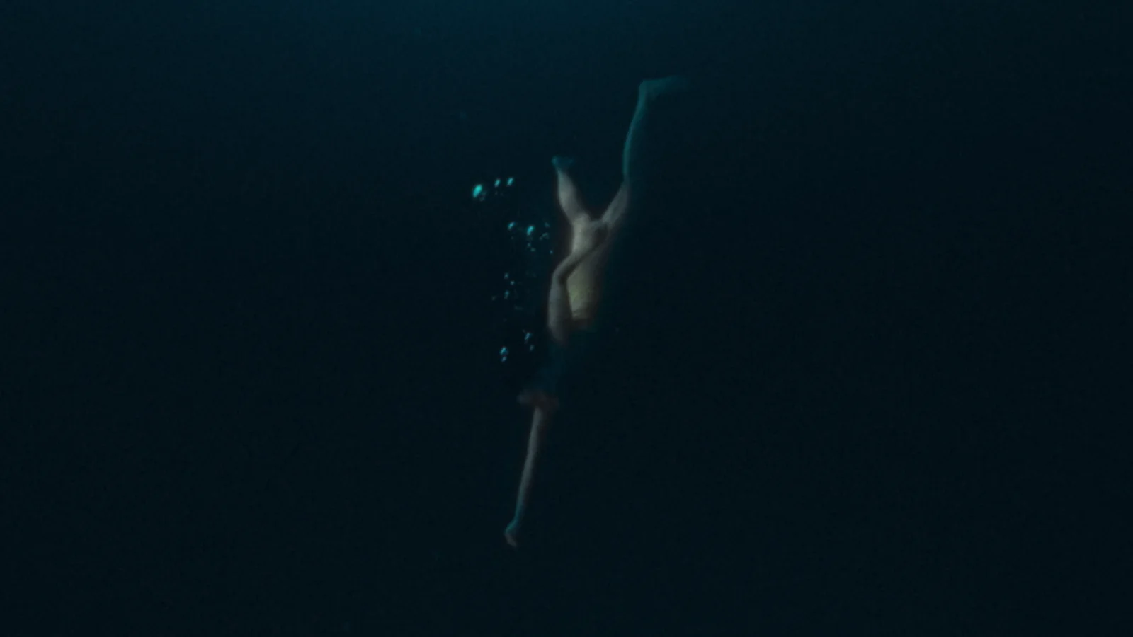 Down Below — a swimmer suspended in dark water